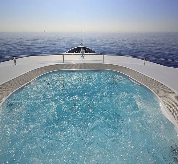 a swimming pool with a building in the background aboard FORWIN Yacht for Sale