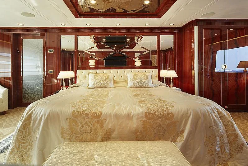 a bed with a large headboard aboard FORWIN Yacht for Sale