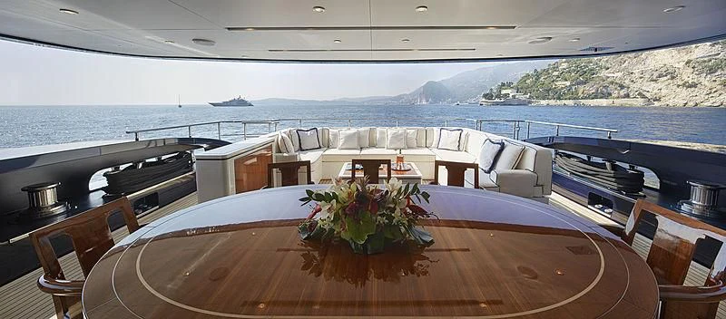 a table with chairs and a plant on it aboard FORWIN Yacht for Sale