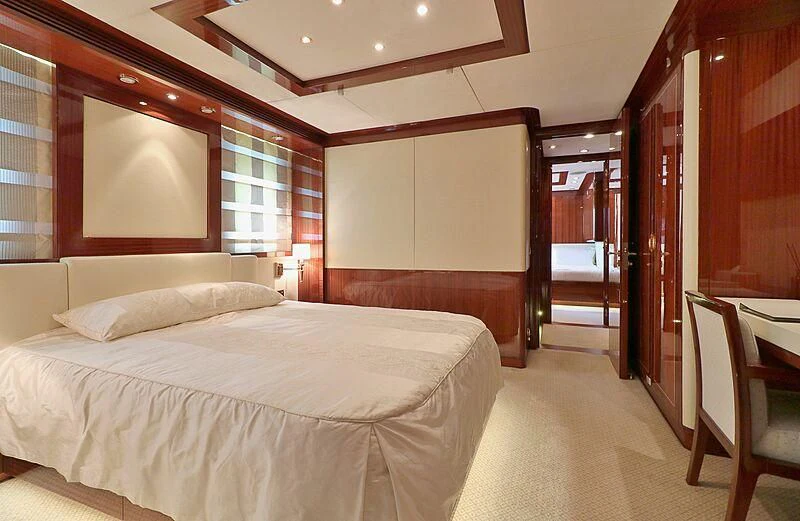 a hotel room with a bed and a table aboard FORWIN Yacht for Sale