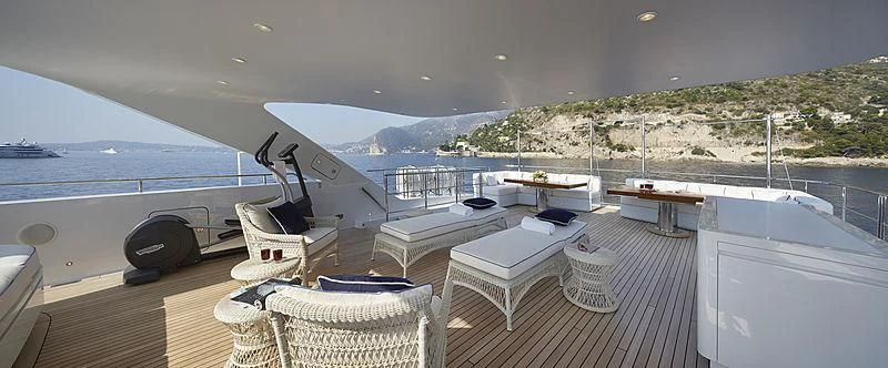 a deck with a view of the ocean and a large boat aboard FORWIN Yacht for Sale