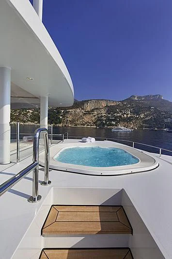 a pool on a deck overlooking a city aboard FORWIN Yacht for Sale