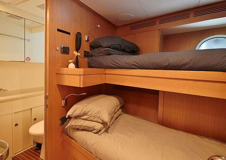 a room with a bed and a mirror aboard FORWIN Yacht for Sale