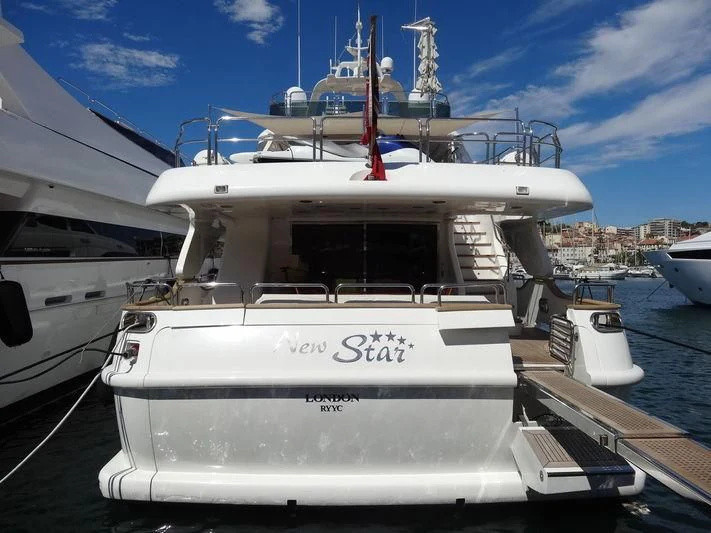 a white boat in a harbor aboard NEW STAR Yacht for Charter