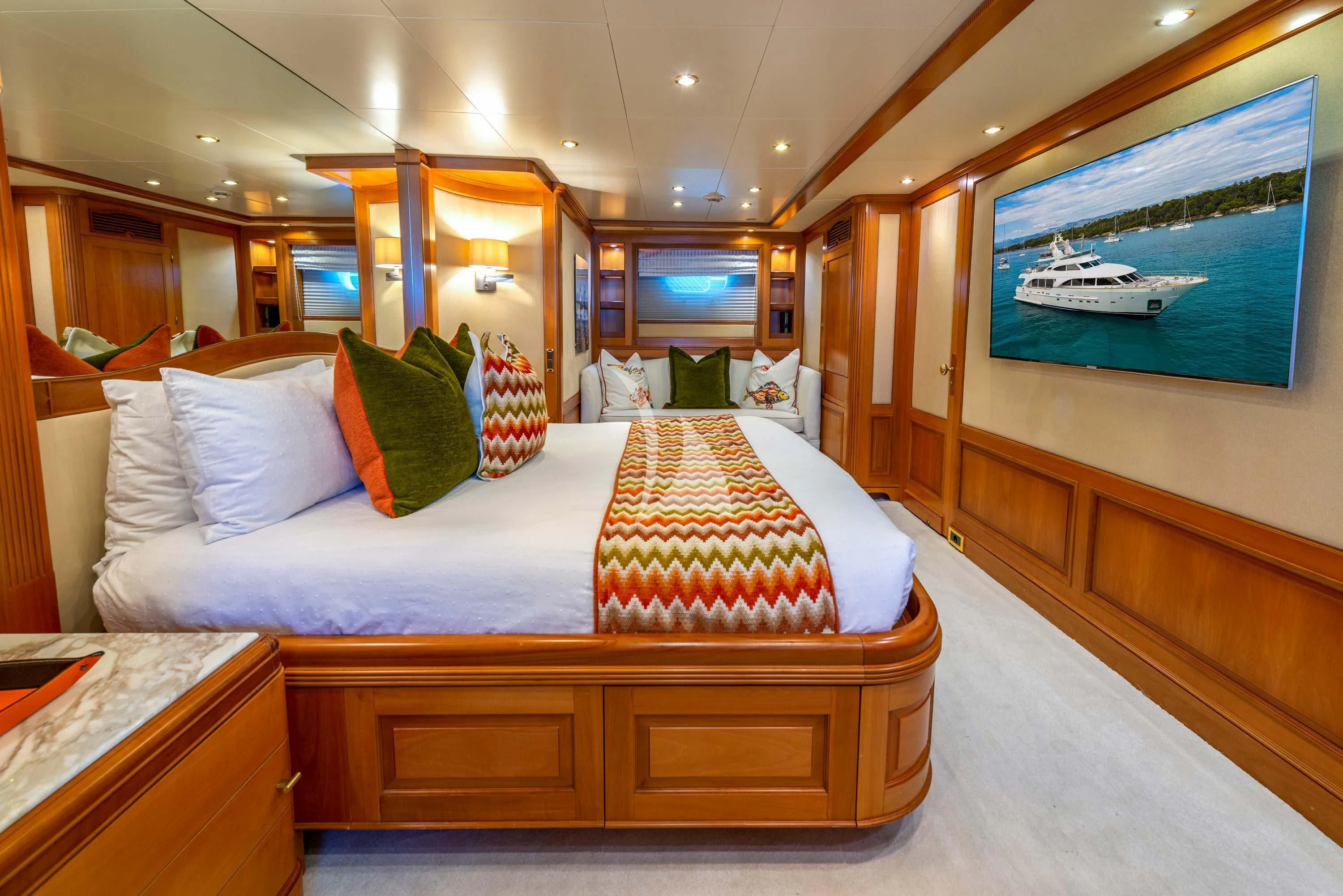 a room with a bed and a television aboard NEW STAR Yacht for Charter