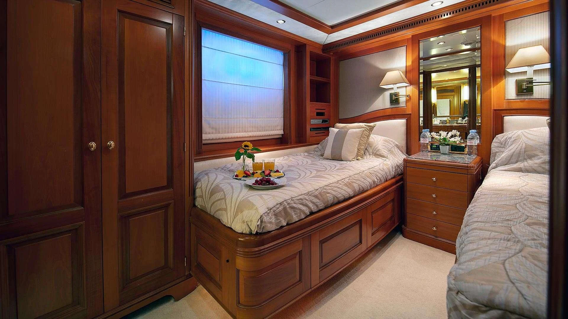 a bedroom with a bed and a mirror aboard NEW STAR Yacht for Charter