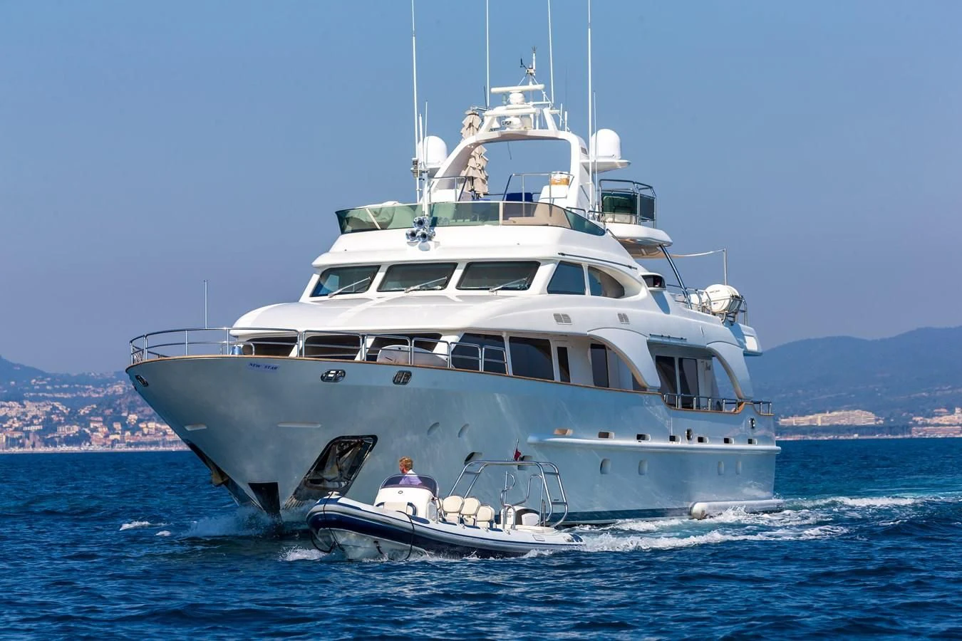a large white boat in the water aboard NEW STAR Yacht for Charter