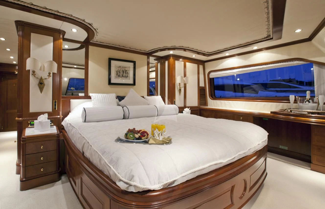 a bed with a television on the wall aboard NEW STAR Yacht for Charter
