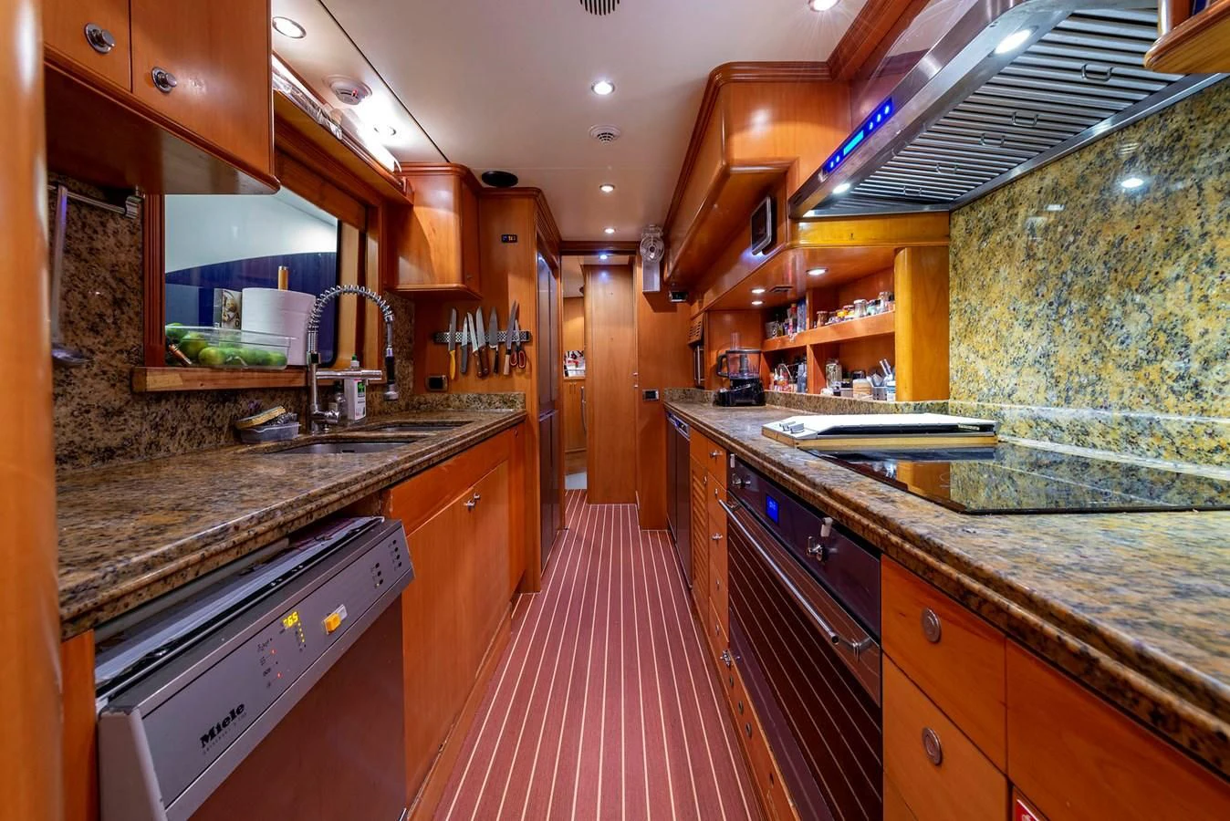 a kitchen with a red rug aboard NEW STAR Yacht for Charter