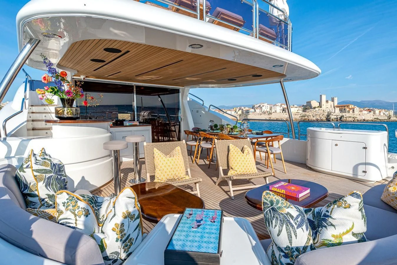 a patio with a table and chairs aboard NEW STAR Yacht for Charter