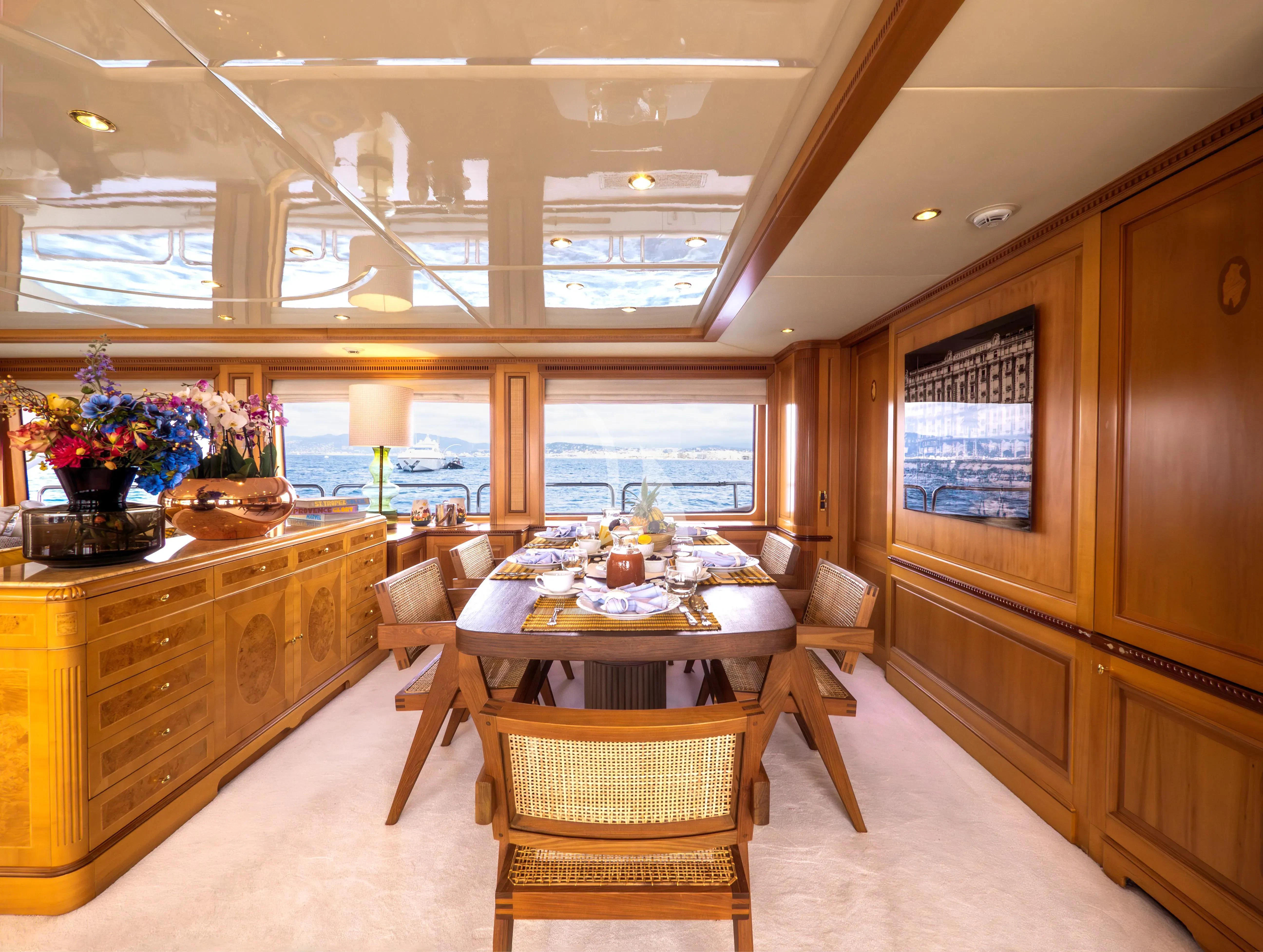 a large kitchen with a dining table aboard NEW STAR Yacht for Charter