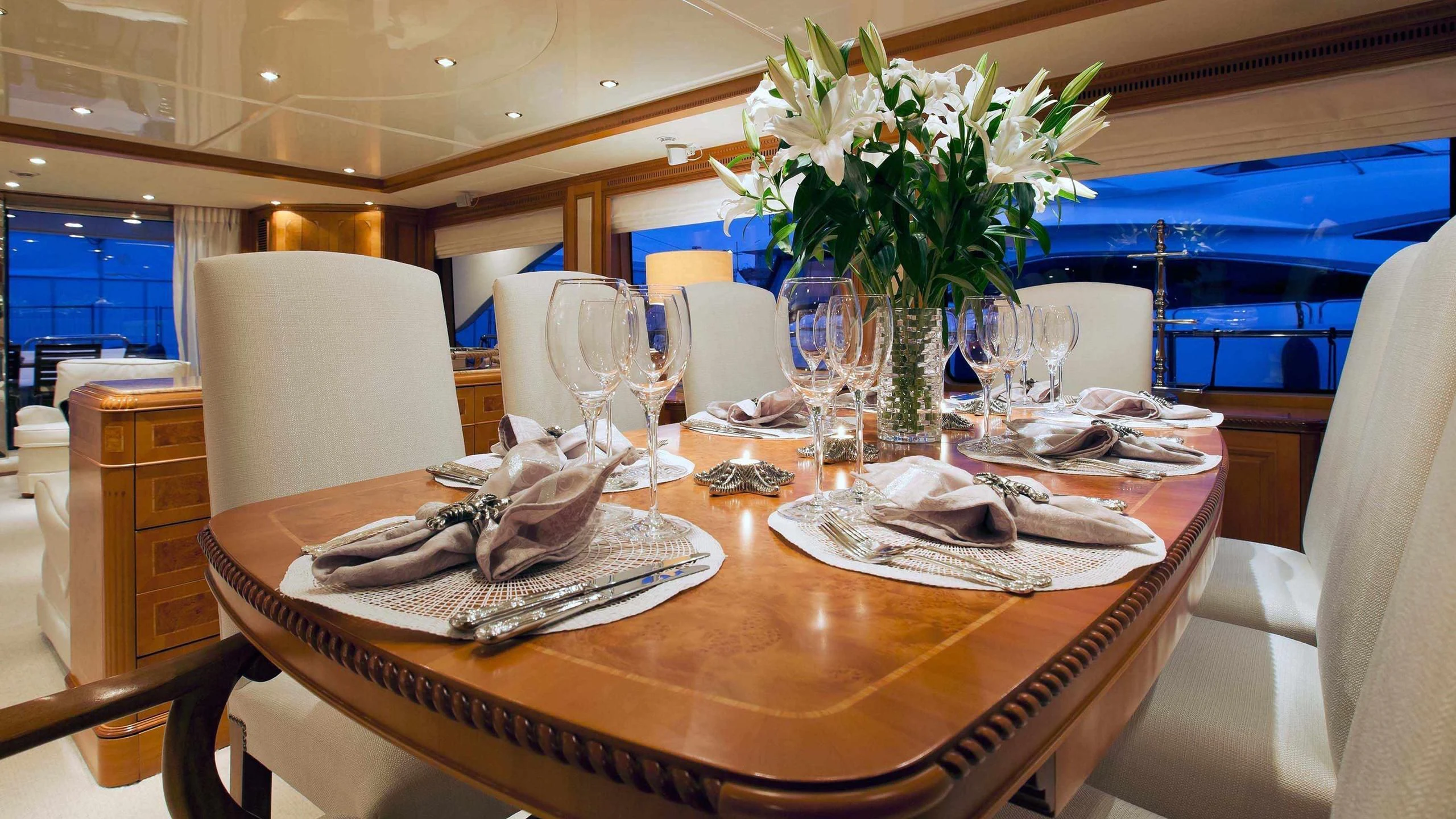 a table with a vase of flowers aboard NEW STAR Yacht for Charter