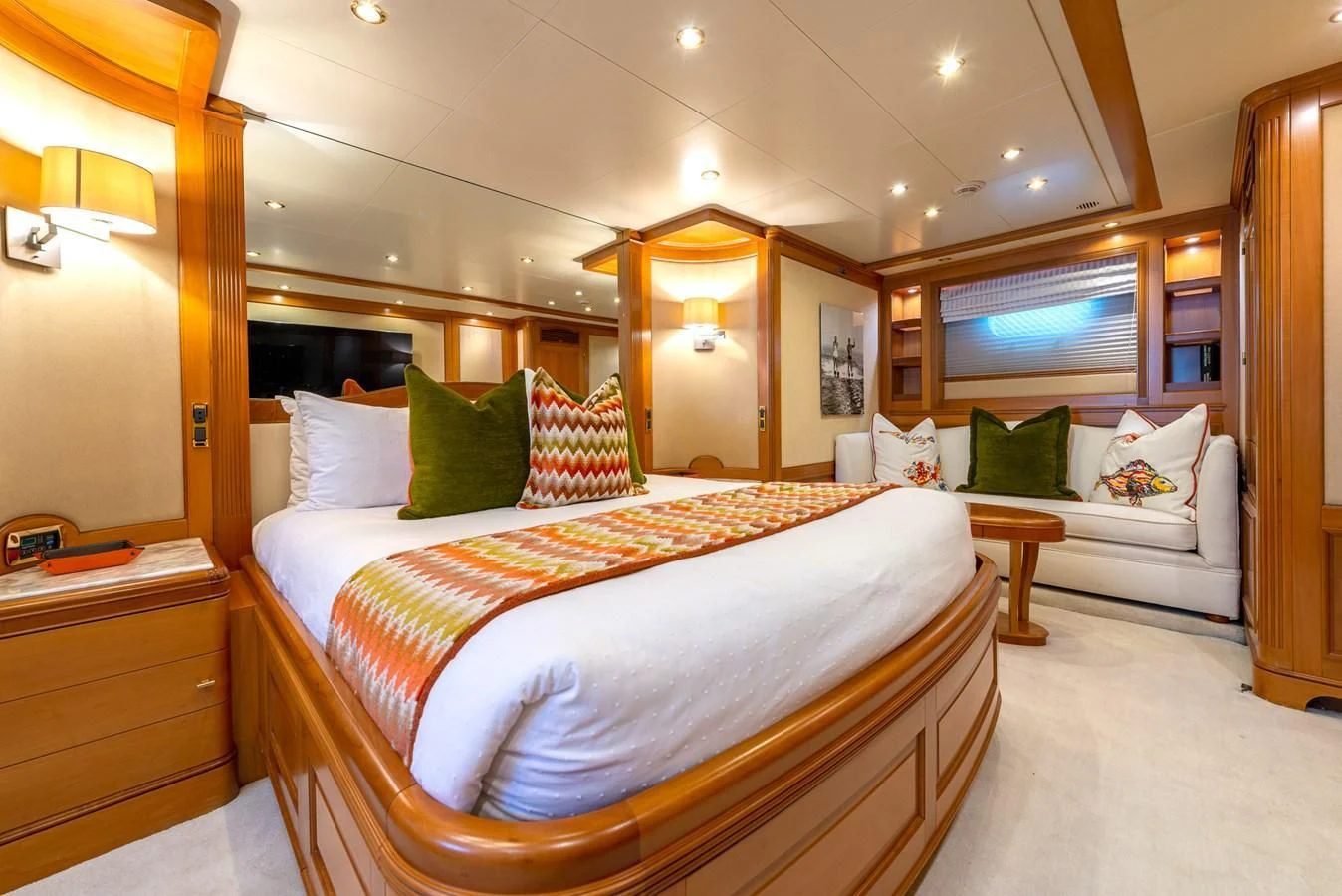 a bedroom with a bed and a mirror aboard NEW STAR Yacht for Charter
