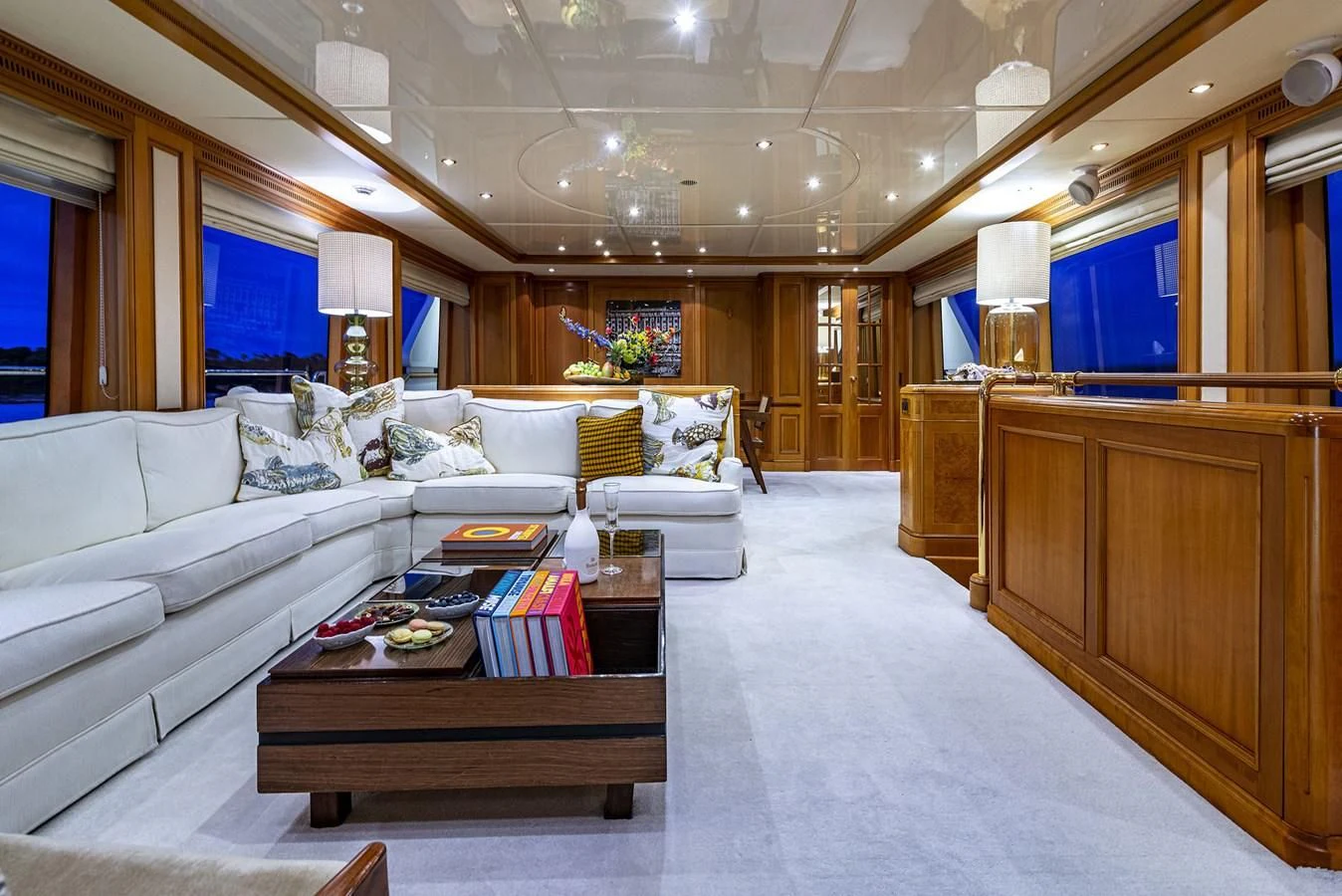 a living room with a large white couch and a wood coffee table aboard NEW STAR Yacht for Charter