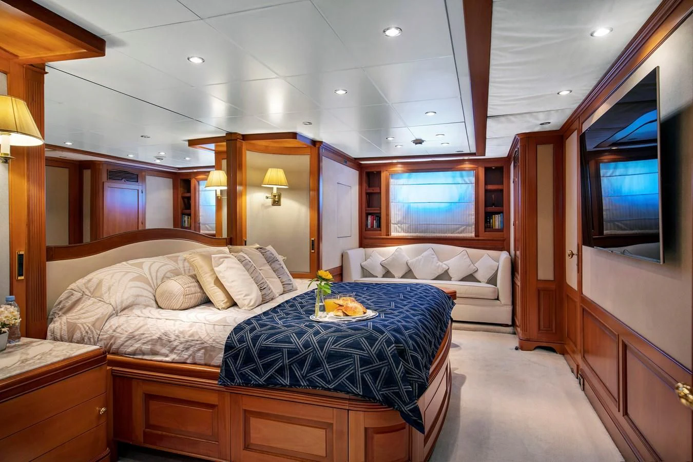 a bedroom with a bed and a television aboard NEW STAR Yacht for Charter