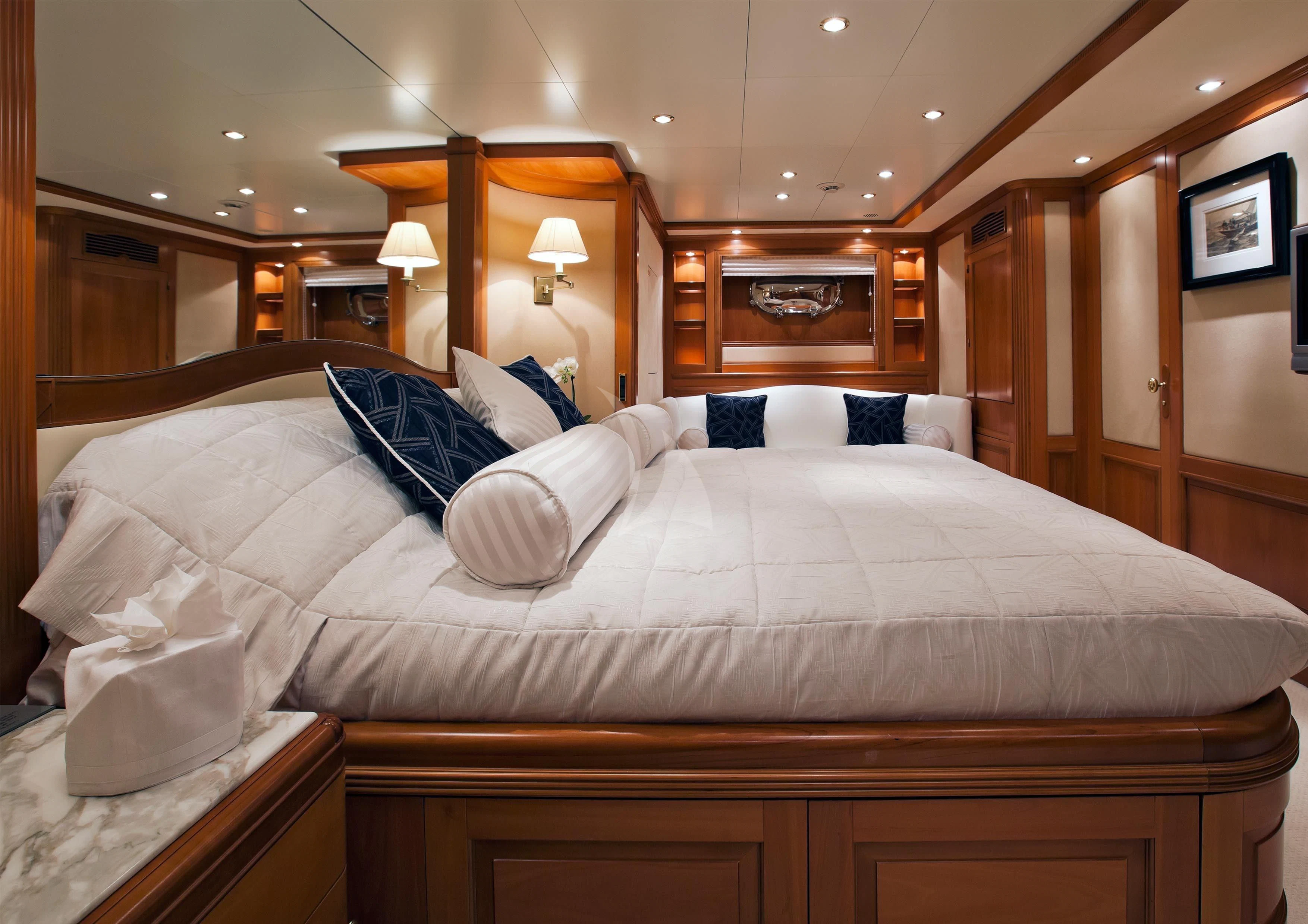 a bed with white sheets aboard NEW STAR Yacht for Charter
