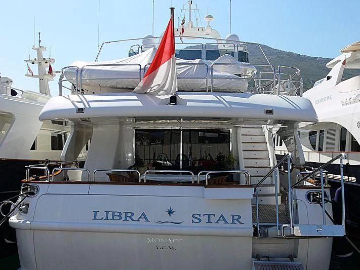 a boat with a flag on the front aboard NEW STAR Yacht for Charter
