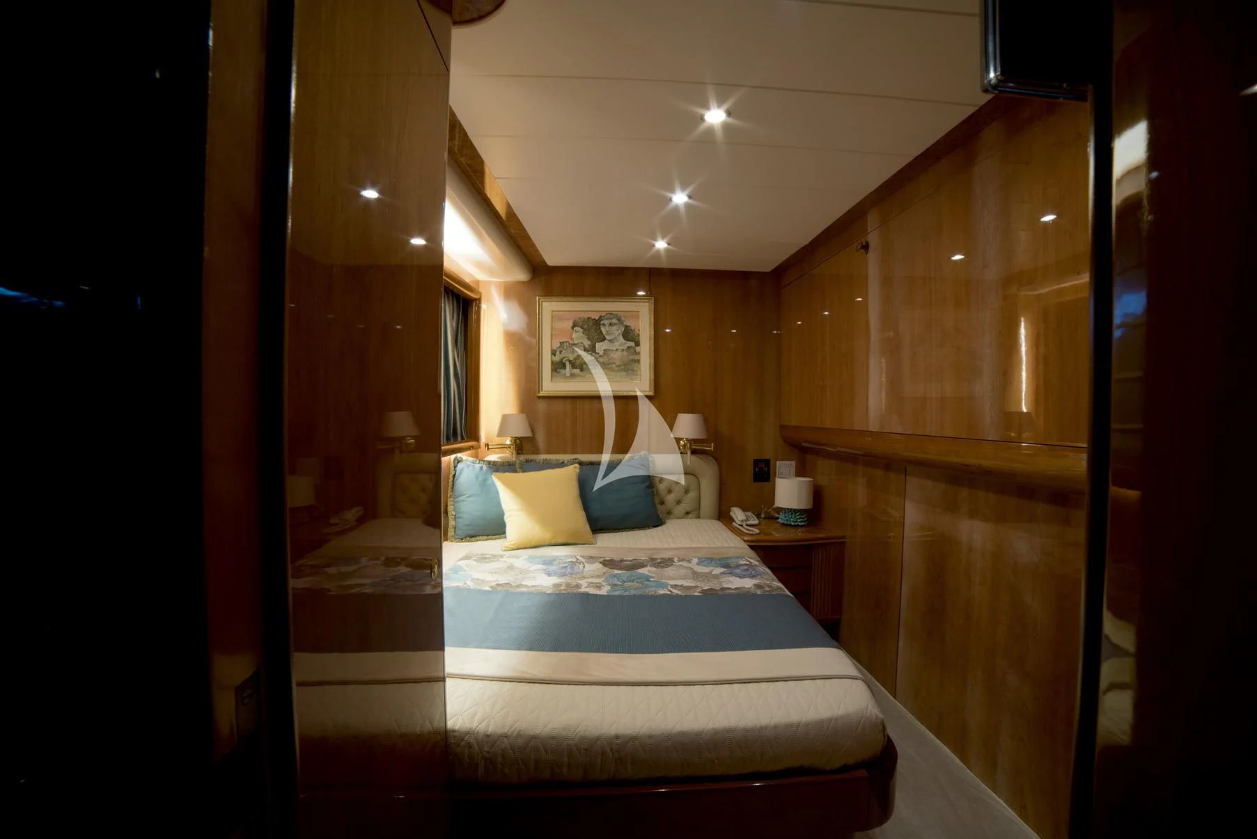 a bedroom with a bed and a wood cabinet aboard D'ARISTOTELIS Yacht for Sale