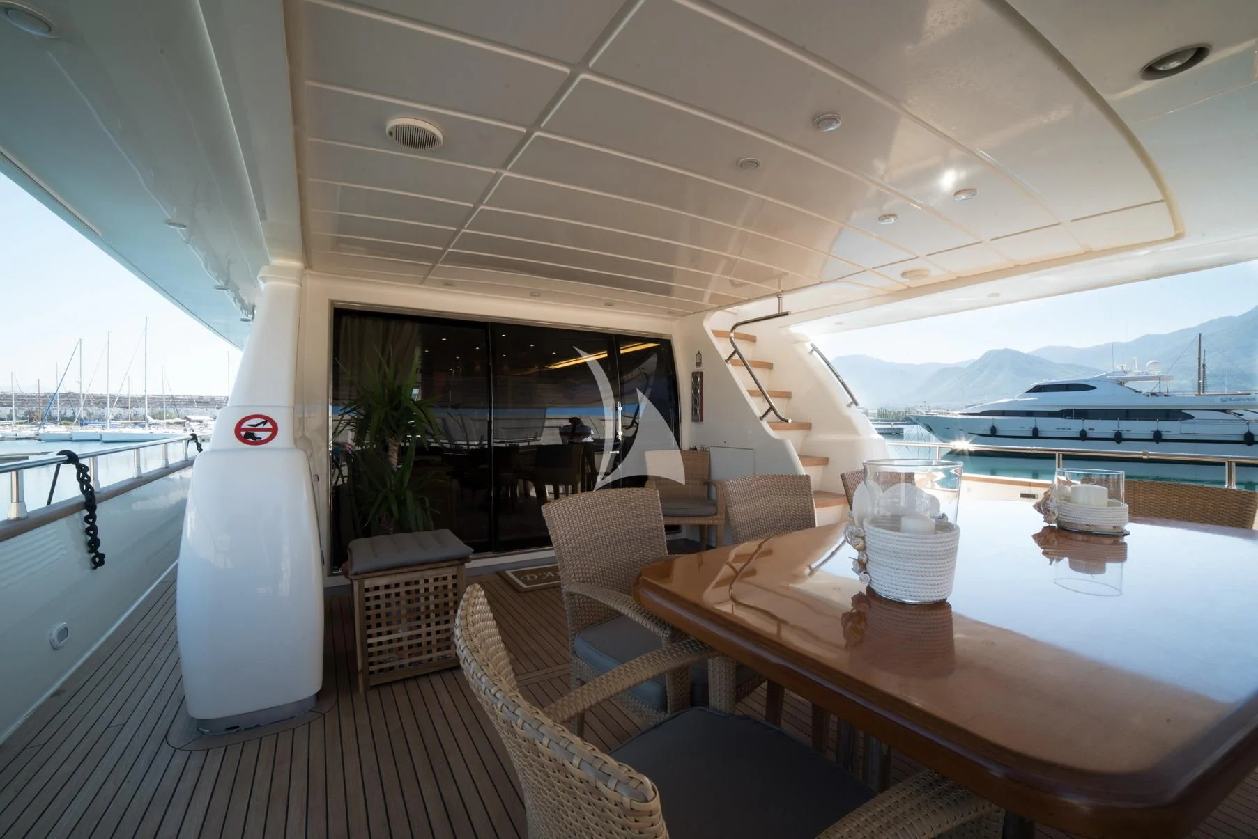 a table with a glass and a white table with chairs on it aboard D'ARISTOTELIS Yacht for Sale