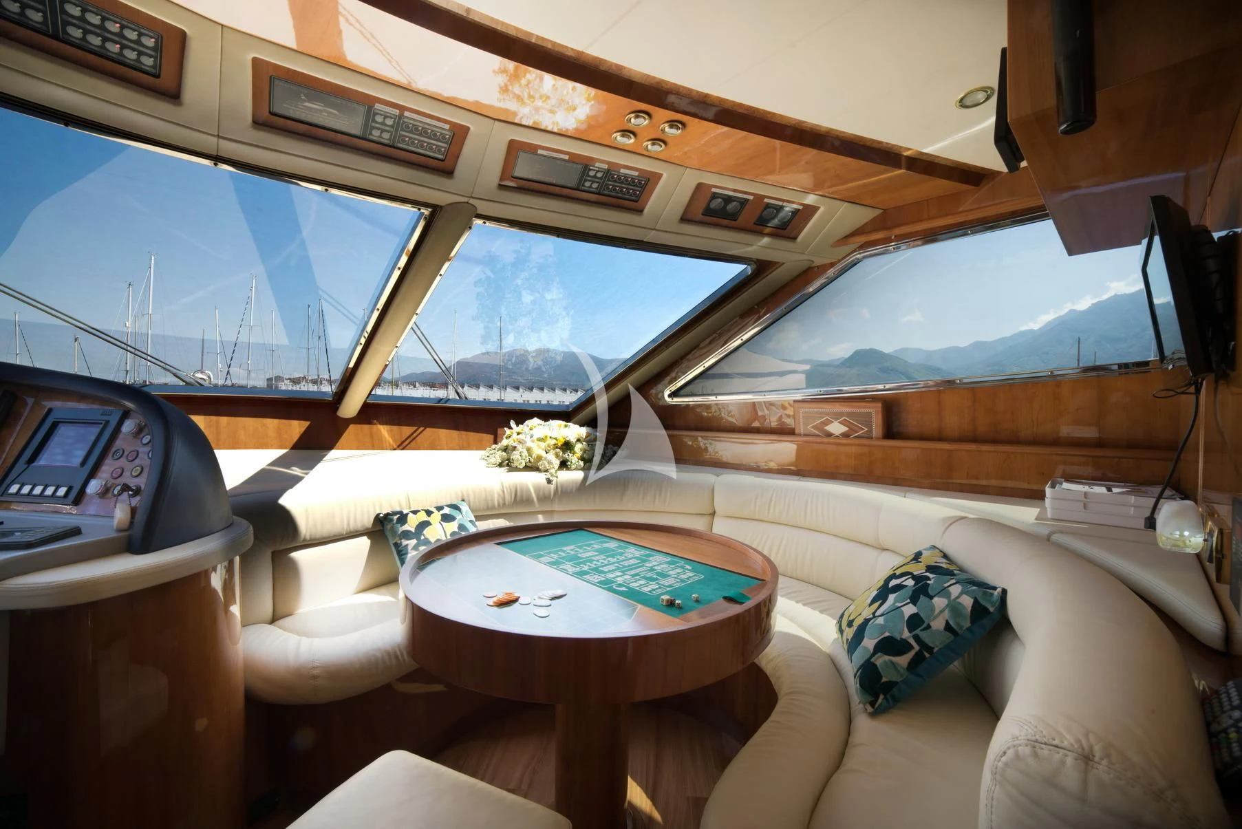 a room with a table and a television aboard D'ARISTOTELIS Yacht for Sale