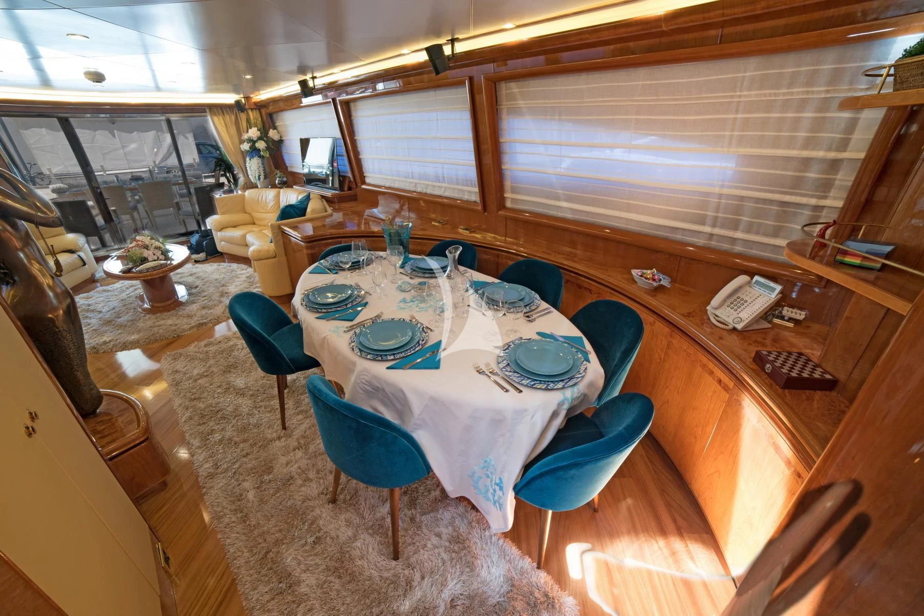 a dining table with plates and chairs aboard D'ARISTOTELIS Yacht for Sale