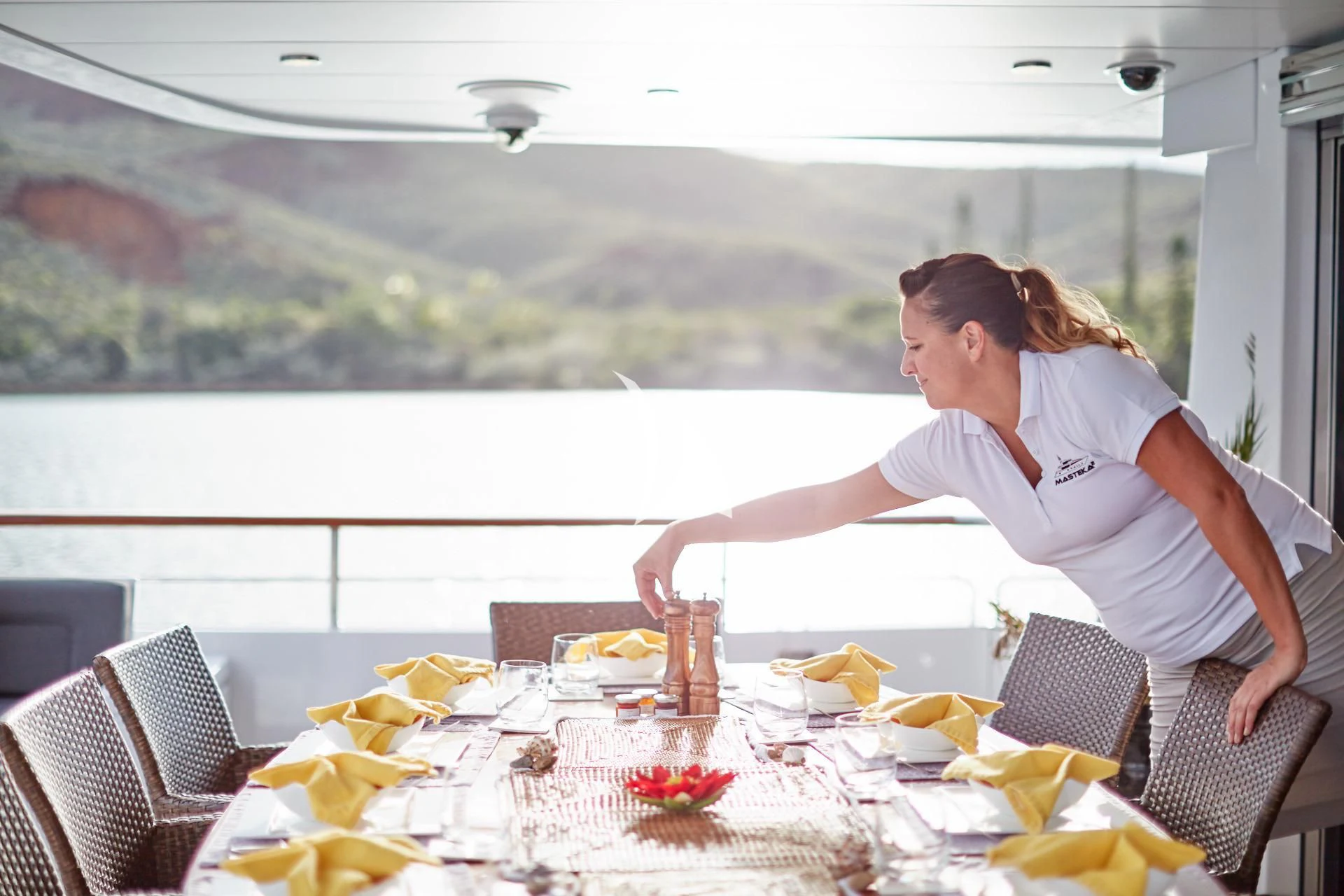a woman sitting at a table aboard MASTEKA 2 Yacht for Charter