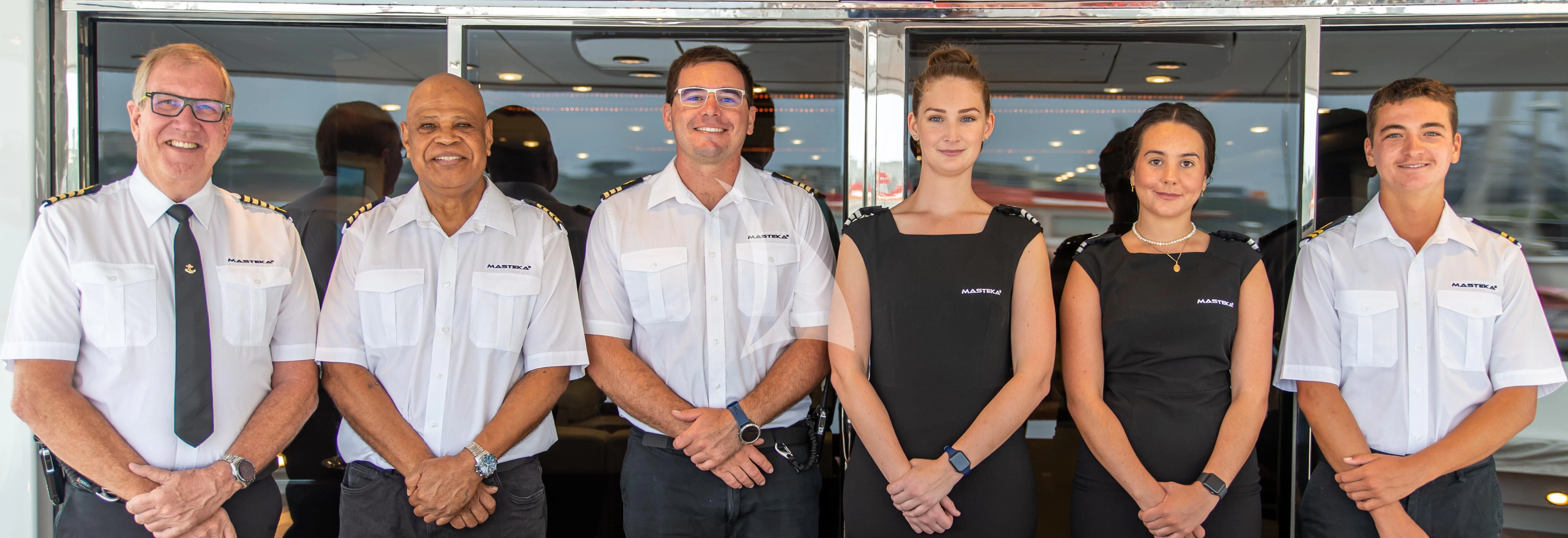 a group of people posing for a photo aboard MASTEKA 2 Yacht for Charter