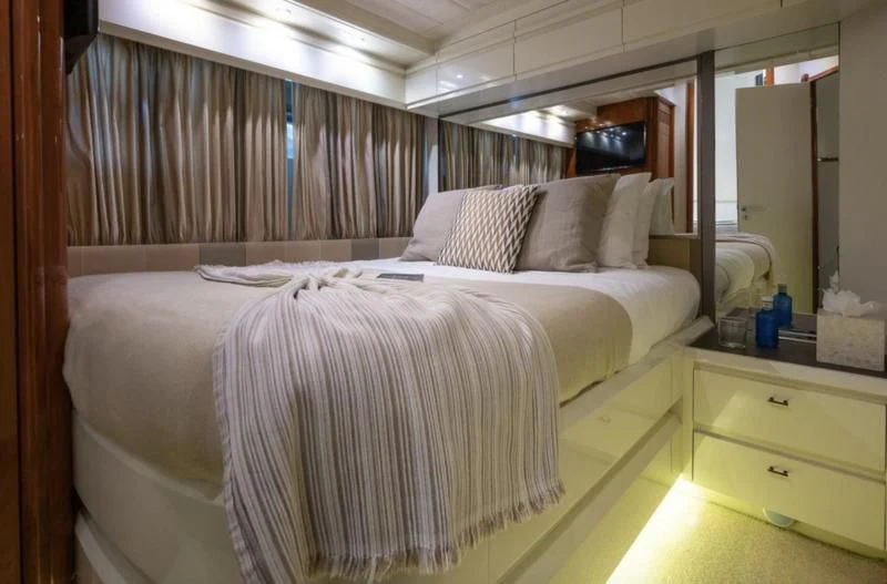 a bed with white sheets aboard WHITE FANG Yacht for Sale