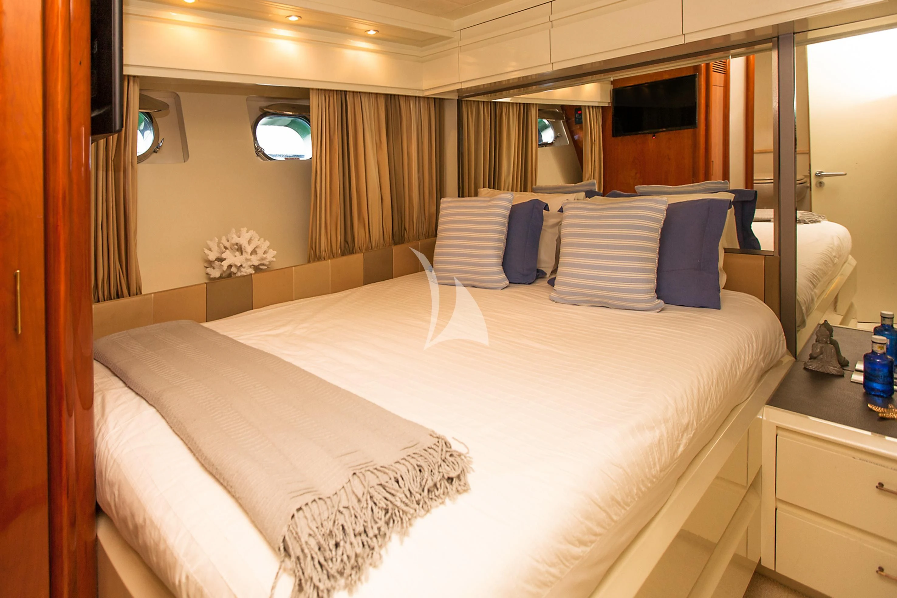 a bed with white sheets and pillows aboard WHITE FANG Yacht for Sale