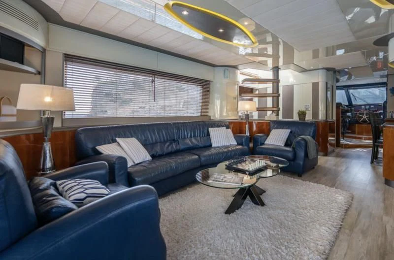 a living room with a blue couch aboard WHITE FANG Yacht for Sale