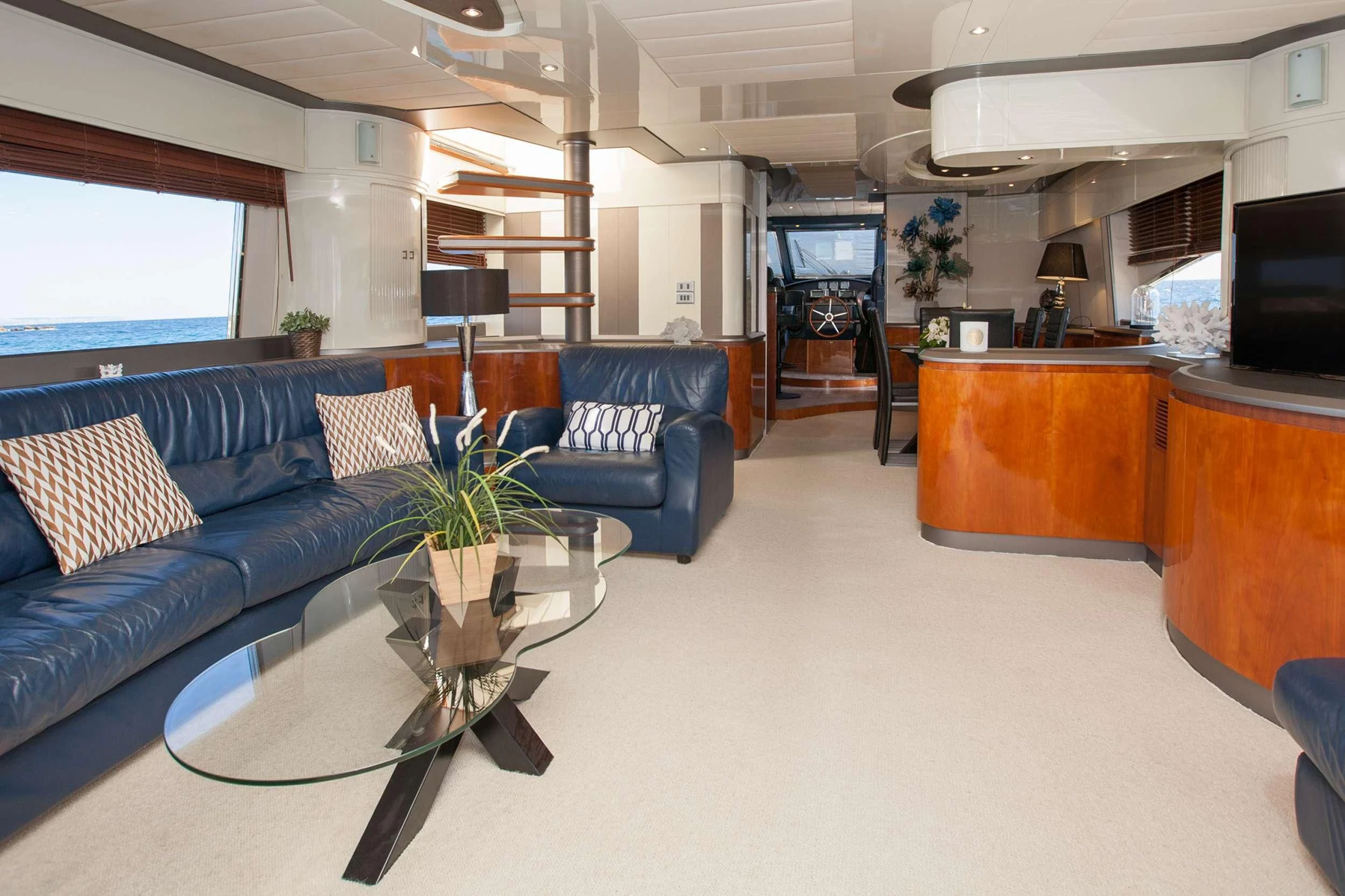 a living room with a blue couch aboard WHITE FANG Yacht for Sale