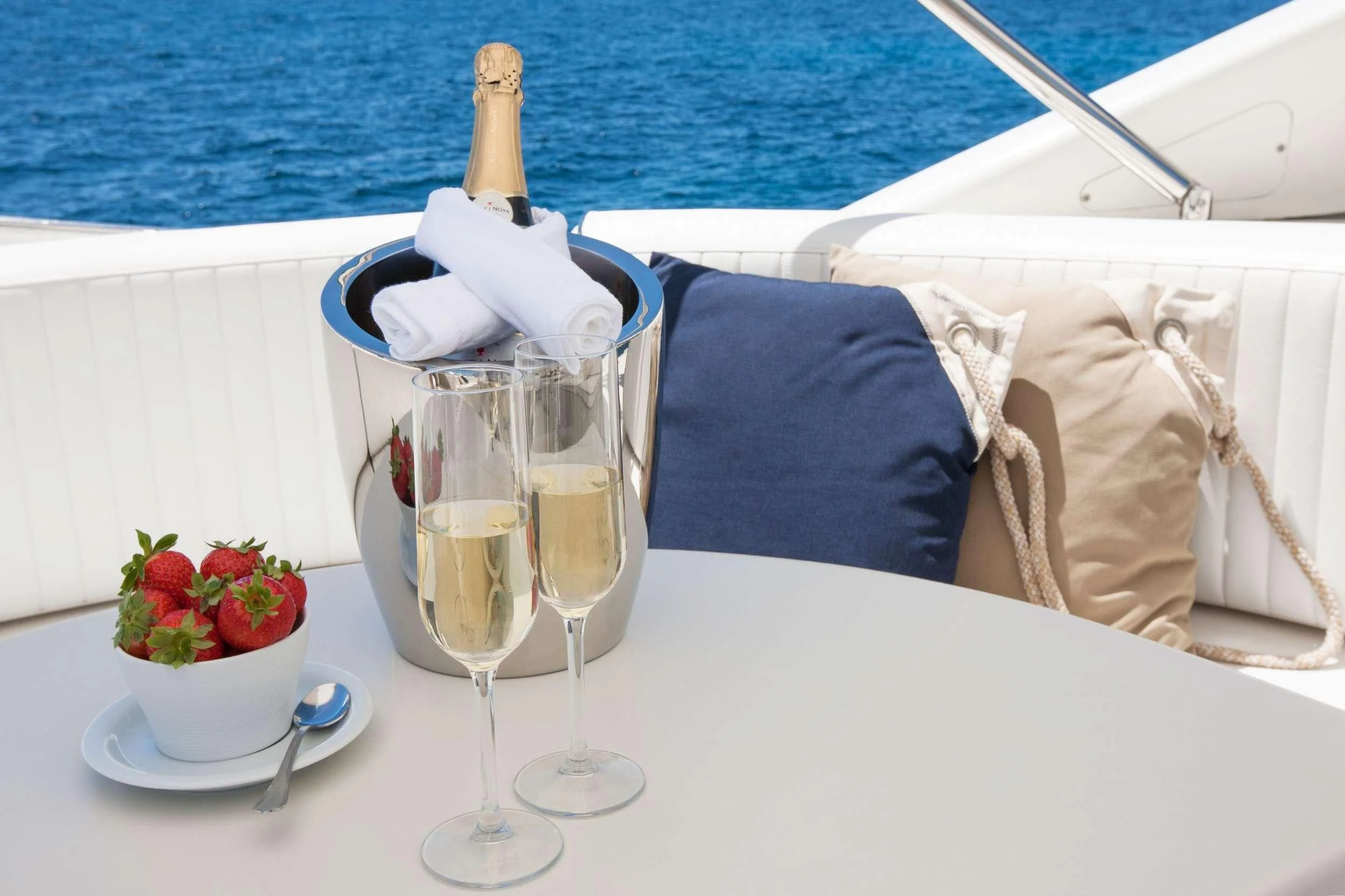 champagne glasses and a bottle on a table with a white tablecloth aboard WHITE FANG Yacht for Sale