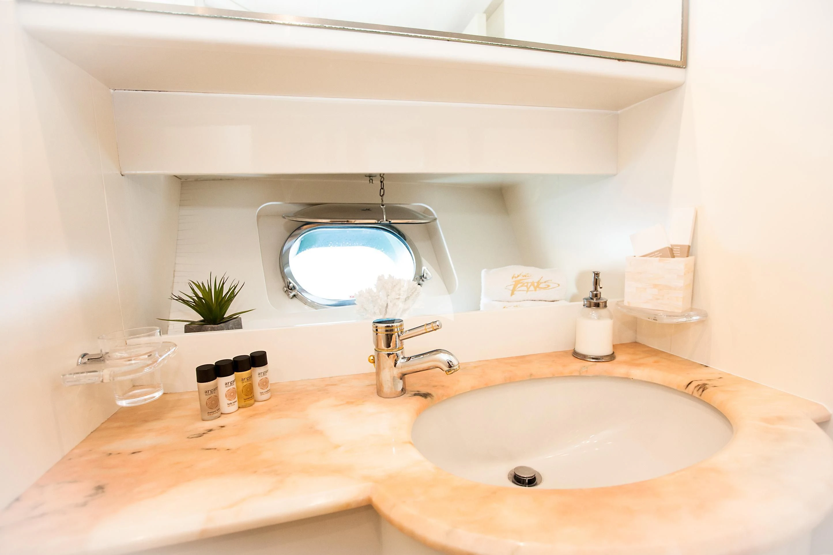 a bathroom with a large mirror aboard WHITE FANG Yacht for Sale