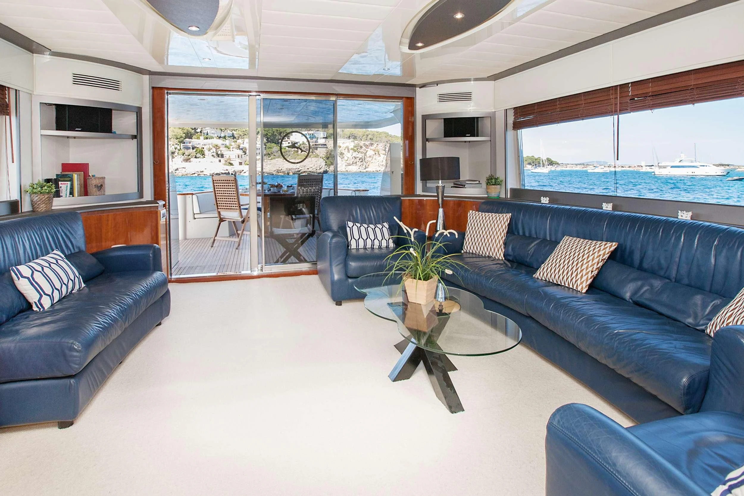 a living room with blue couches aboard WHITE FANG Yacht for Sale