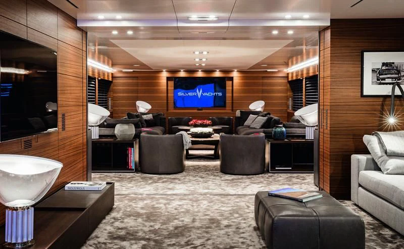 a large living room with a large screen aboard SILVER FAST Yacht for Sale