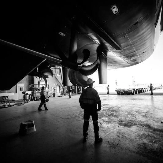 a group of people standing under a plane aboard SILVER FAST Yacht for Sale