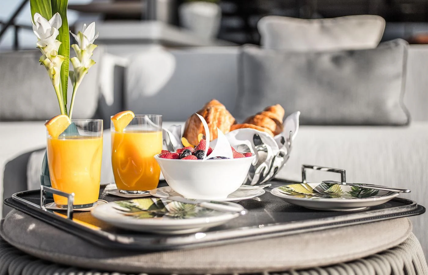 a table with plates of food and drinks on it aboard SEVERIN°S Yacht for Charter