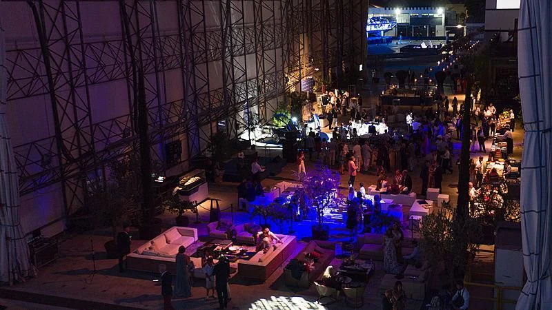 a large crowd of people in a large room with a large window aboard SEVERIN°S Yacht for Charter