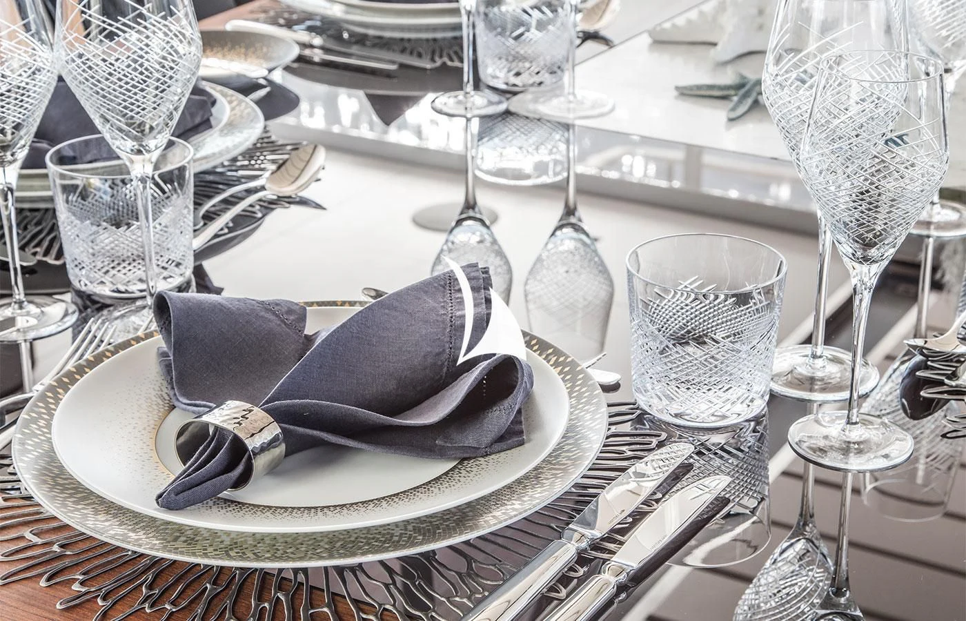 a plate with a napkin and glasses on it aboard SEVERIN°S Yacht for Charter