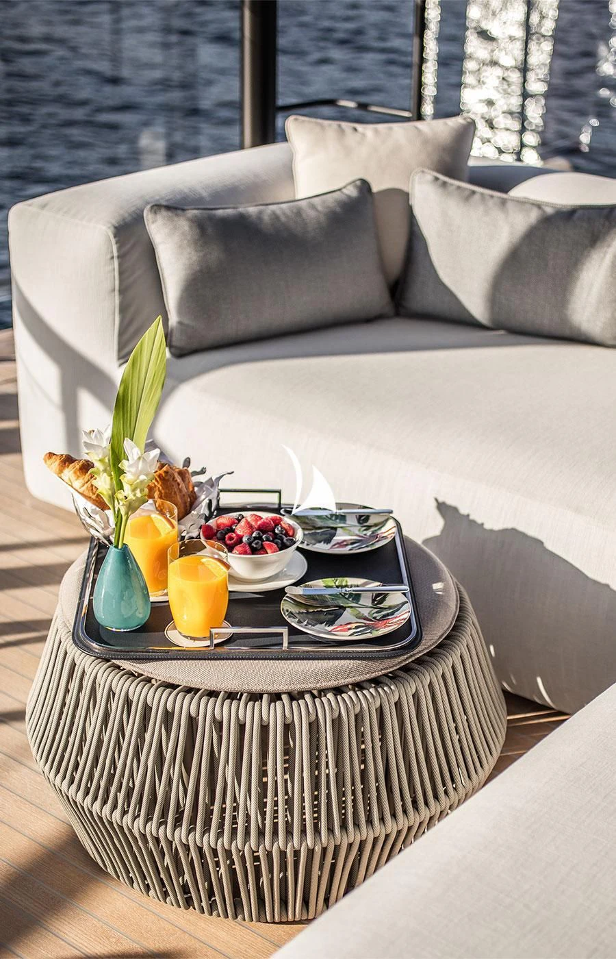 a table with a plate of food and a plant on it aboard SEVERIN°S Yacht for Charter