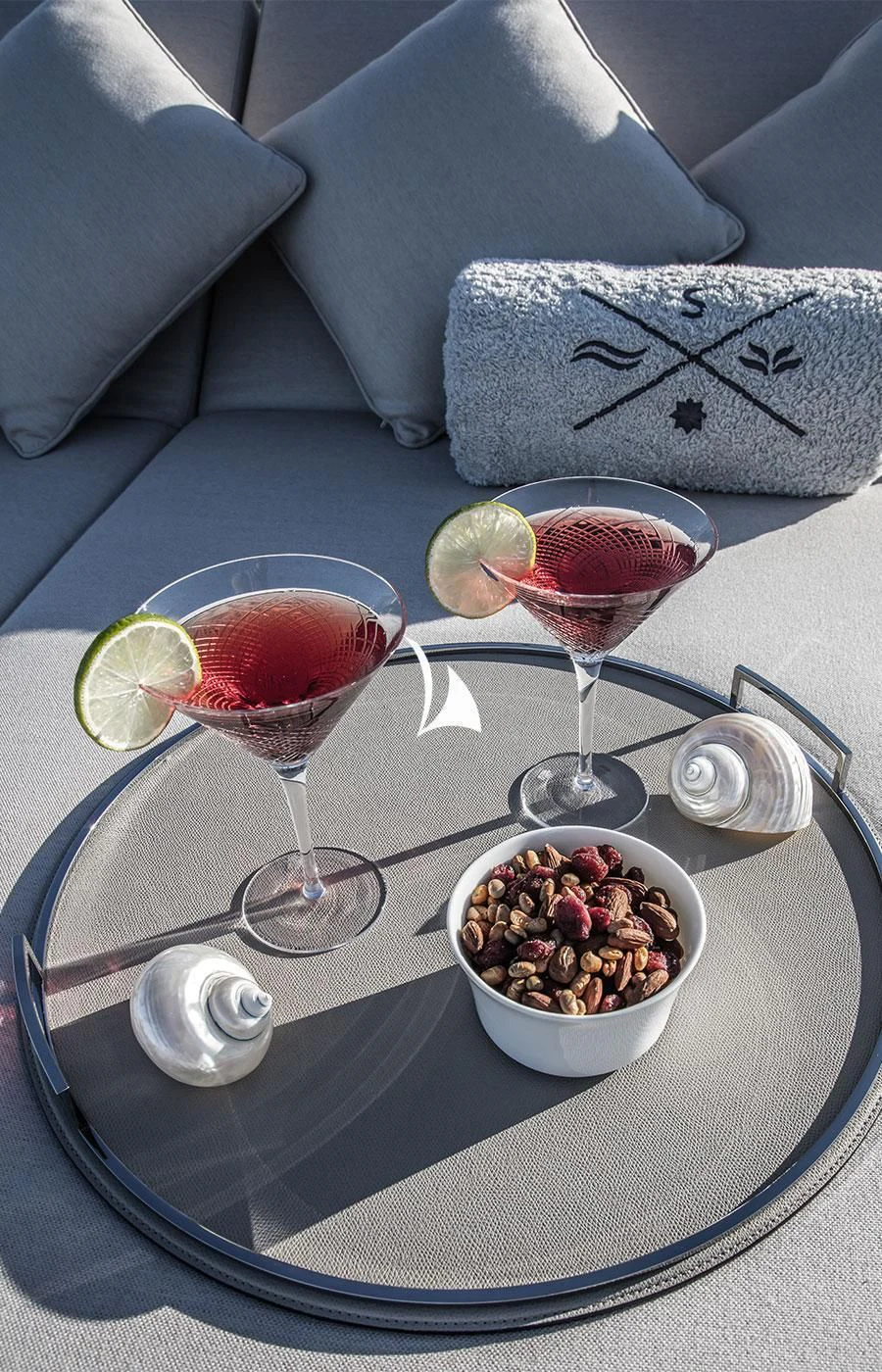 a table with a bowl of fruit and a glass of wine aboard SEVERIN°S Yacht for Charter