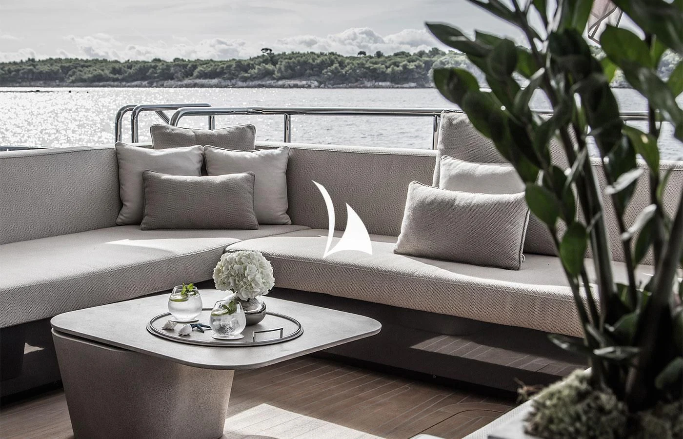 a white couch with a white coffee table and white pillows aboard SEVERIN°S Yacht for Charter