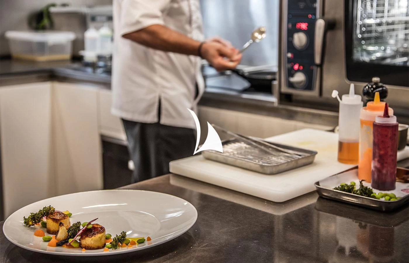 a person preparing food in a kitchen aboard SEVERIN°S Yacht for Charter