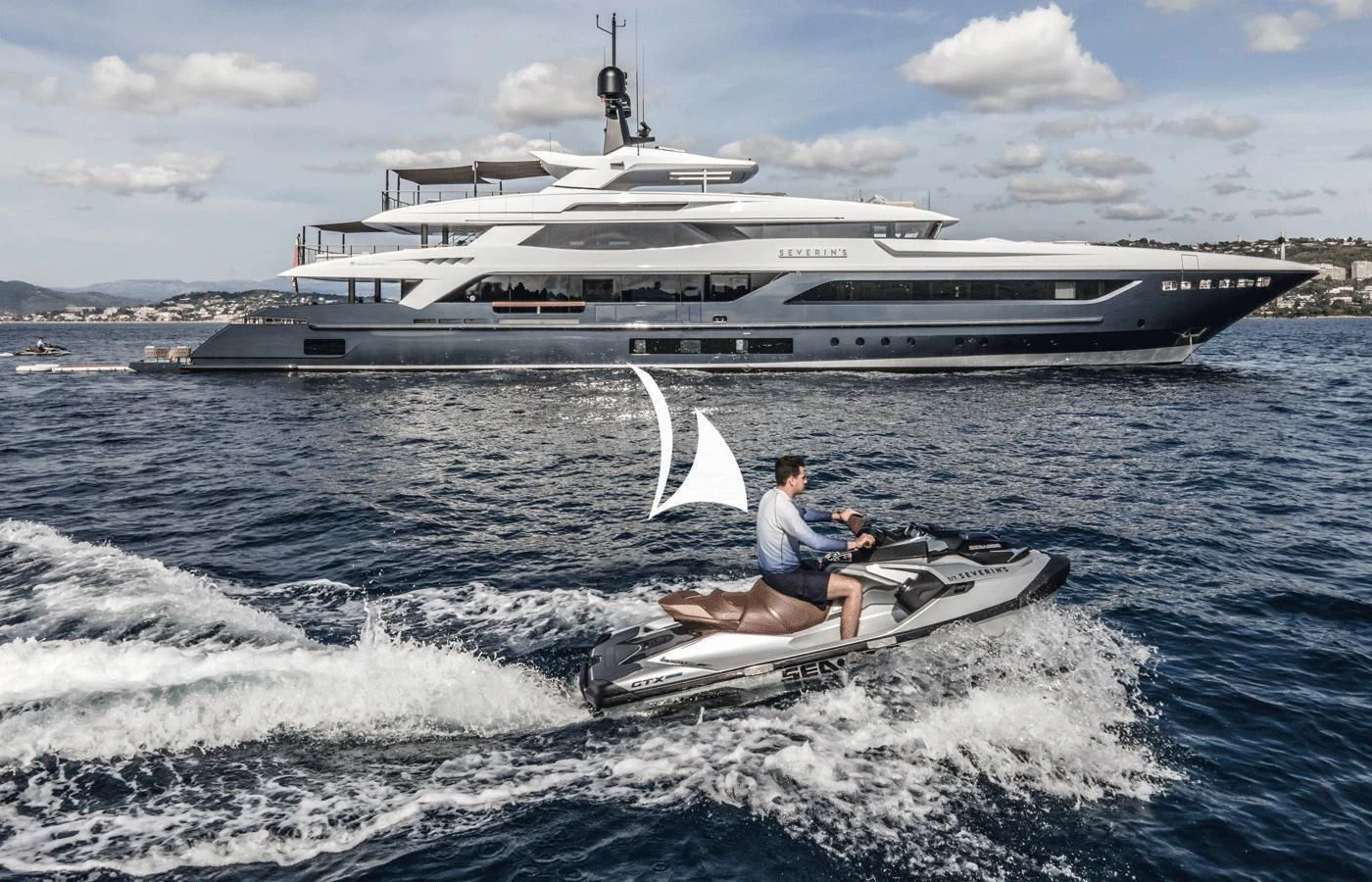 a person on a jet ski in the water with a large ship in the background aboard SEVERIN°S Yacht for Charter