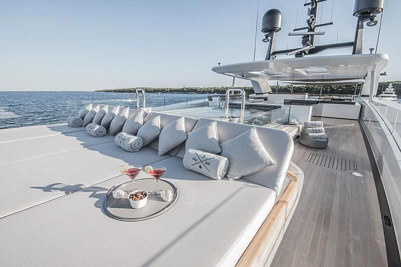 a deck with a couch and a pool on it aboard SEVERIN°S Yacht for Charter