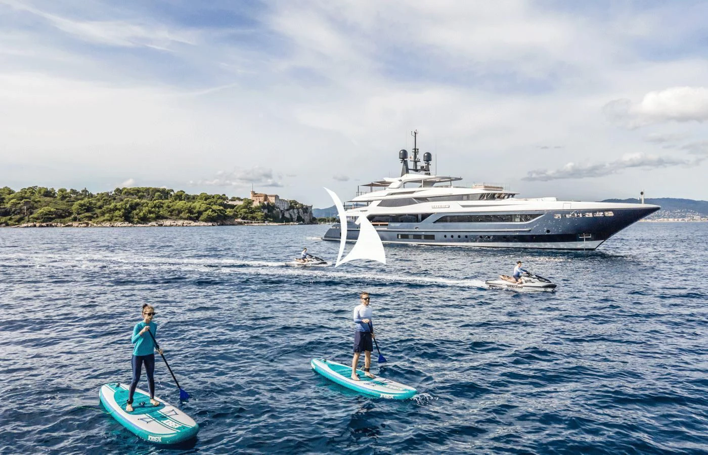 a couple of people on surfboards in the water with a boat in the background aboard SEVERIN°S Yacht for Charter