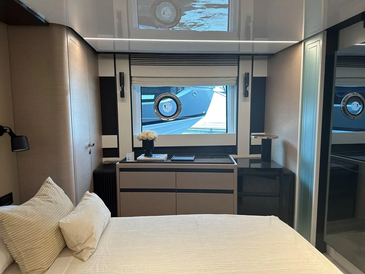 a bed with a tv on the wall aboard SUNSET 8 Yacht for Sale