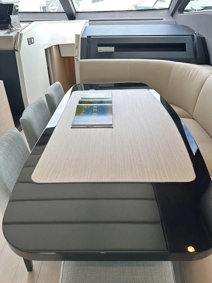 a table with a book on it aboard SUNSET 8 Yacht for Sale