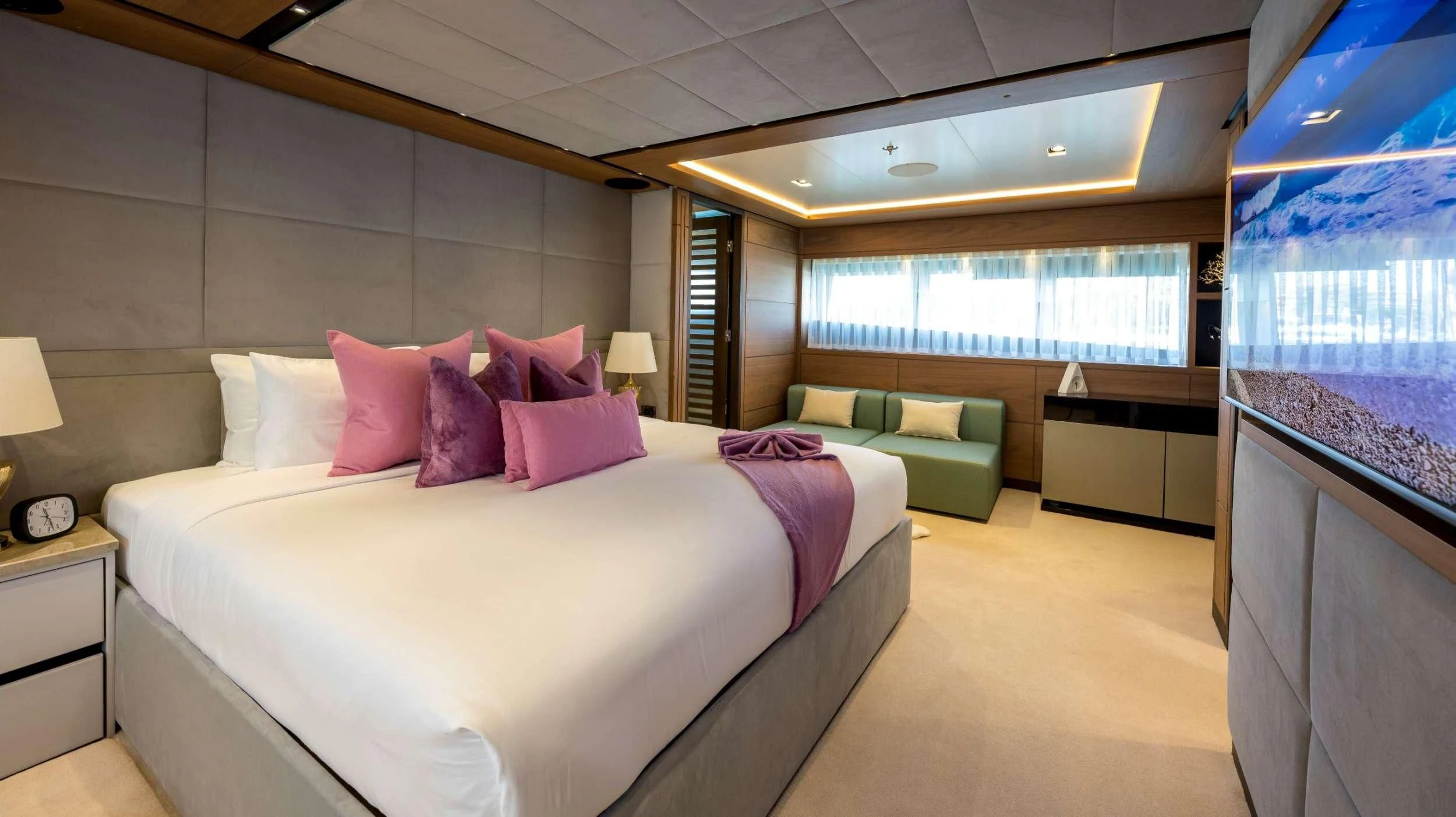 a large bedroom with a bed and a window aboard NAVIS ONE Yacht for Charter
