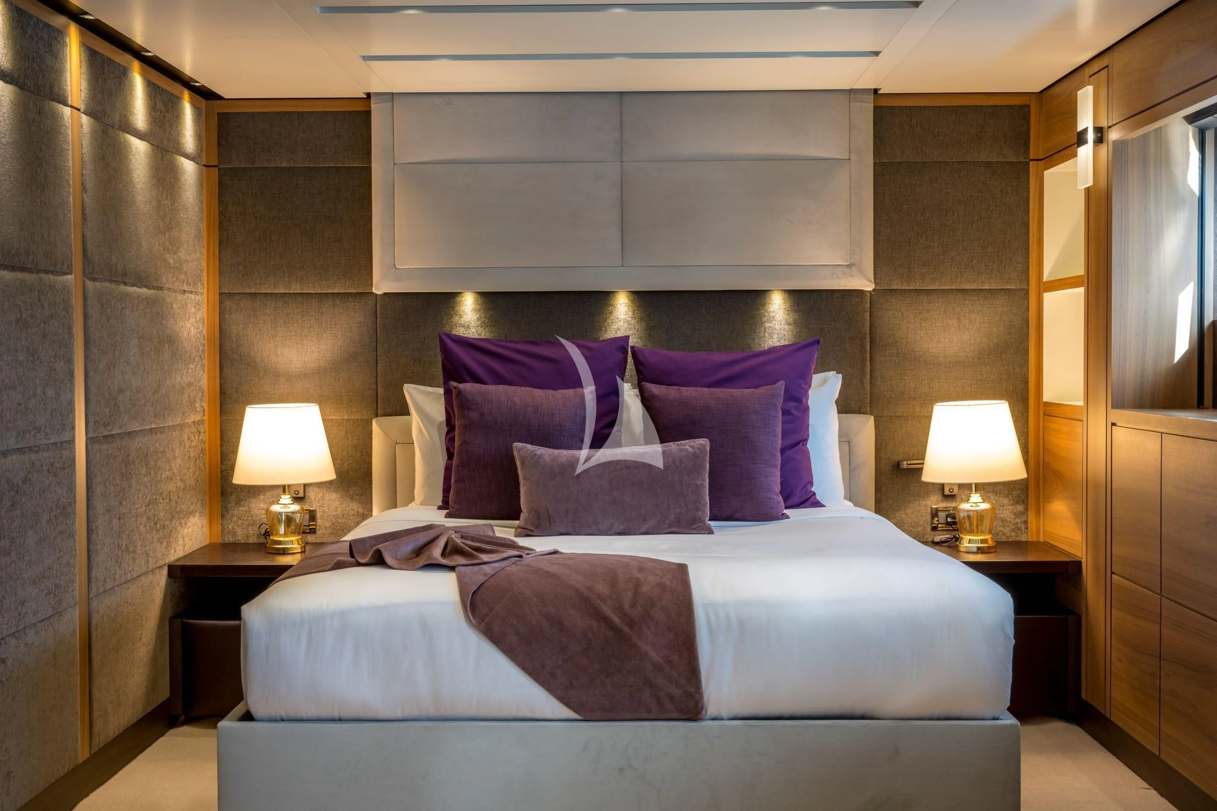 a bed with pillows and pillows aboard NAVIS ONE Yacht for Charter